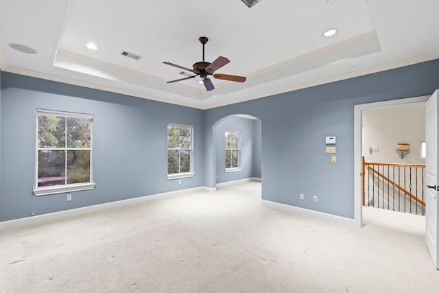 6230 Elm Heights Ln, Houston, TX 77081 - carpeted empty room featuring a tray ceiling, a ceiling fan, crown molding, arched walkways, and baseboards