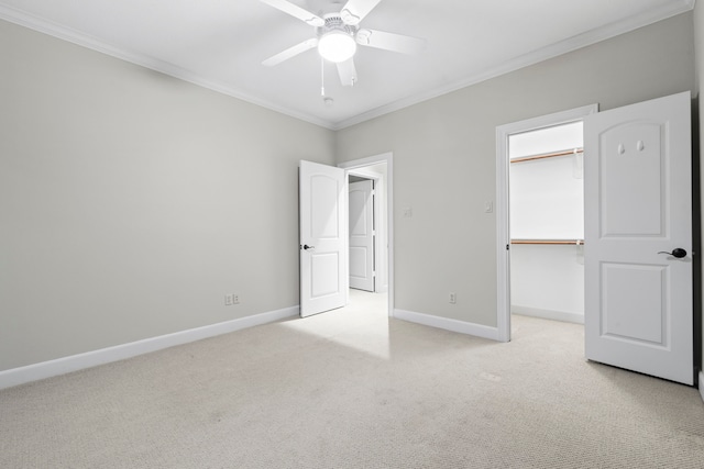 6230 Elm Heights Ln, Houston, TX 77081 - unfurnished bedroom featuring crown molding, light carpet, baseboards, a walk in closet, and a closet