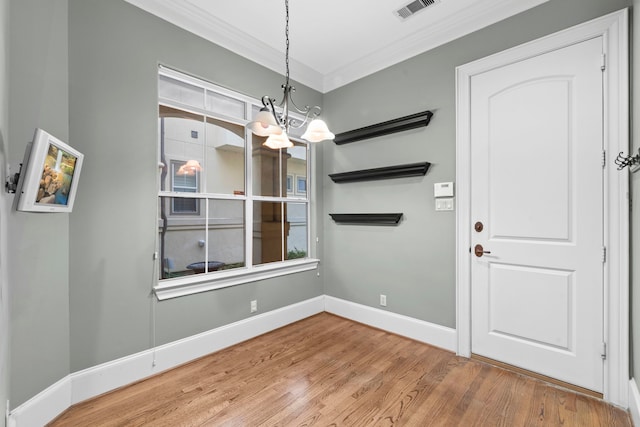 6230 Elm Heights Ln, Houston, TX 77081 - unfurnished dining area featuring a chandelier, ornamental molding, wood finished floors, and baseboards