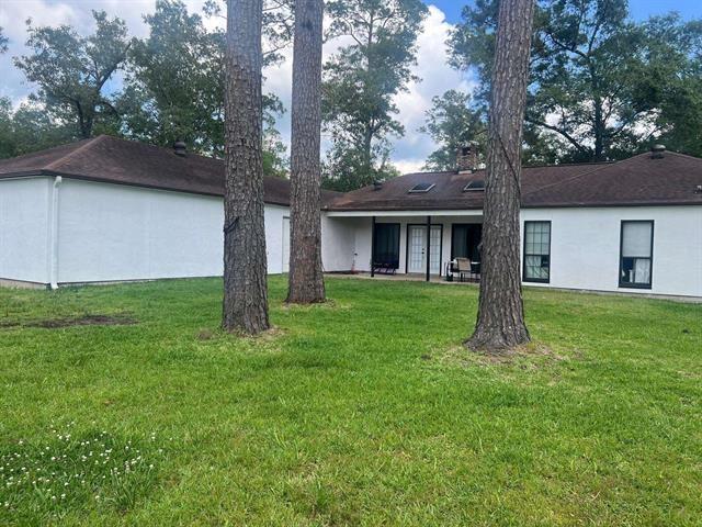 13375 Craig Ln, Bevil Oaks, TX 77713 - rear view of property with a yard