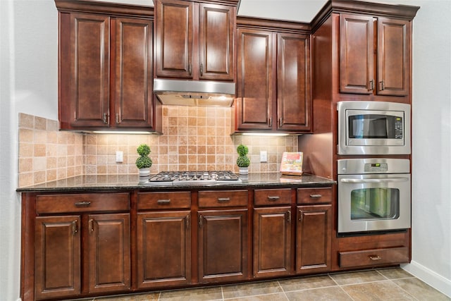 27259 Jessica Hills Ln, Spring, TX 77386 - kitchen with appliances with stainless steel finishes, extractor fan, dark stone countertops, and tasteful backsplash