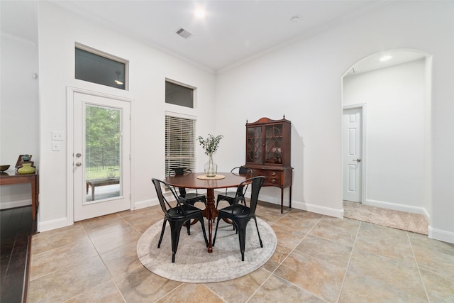 27259 Jessica Hills Ln, Spring, TX 77386 - dining area featuring crown molding, arched walkways, light tile patterned flooring, and baseboards