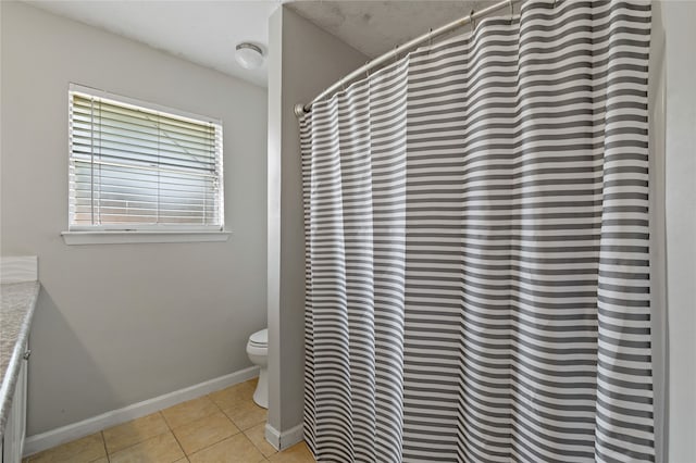 19411 Southaven Dr, Houston, TX 77084 - bathroom featuring tile patterned floors, toilet, baseboards, a shower with shower curtain, and vanity