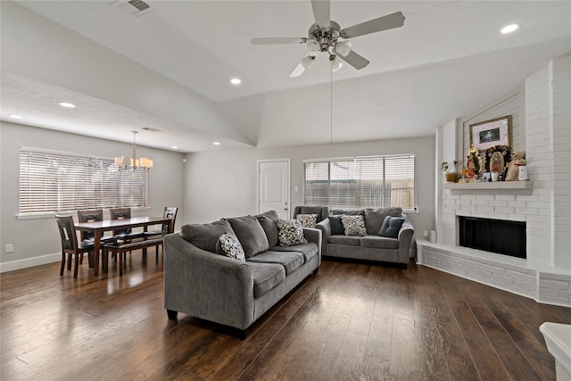 19411 Southaven Dr, Houston, TX 77084 - living room with lofted ceiling, dark wood-style floors, a fireplace, a ceiling fan, and a chandelier