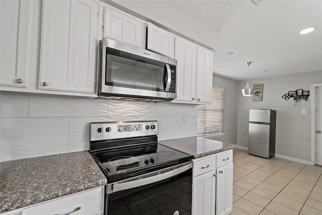 19411 Southaven Dr, Houston, TX 77084 - kitchen with appliances with stainless steel finishes, tasteful backsplash, white cabinetry, baseboards, and light tile patterned flooring