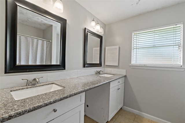 19411 Southaven Dr, Houston, TX 77084 - full bathroom featuring baseboards, tile patterned floors, and double vanity