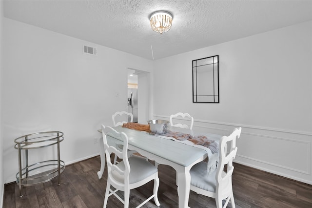 16419 Fox Crossing Ln, Spring, TX 77379 - dining space featuring a textured ceiling and wood finished floors
