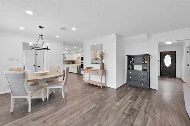 16419 Fox Crossing Ln, Spring, TX 77379 - dining space featuring recessed lighting, dark wood finished floors, a chandelier, ornamental molding, and baseboards