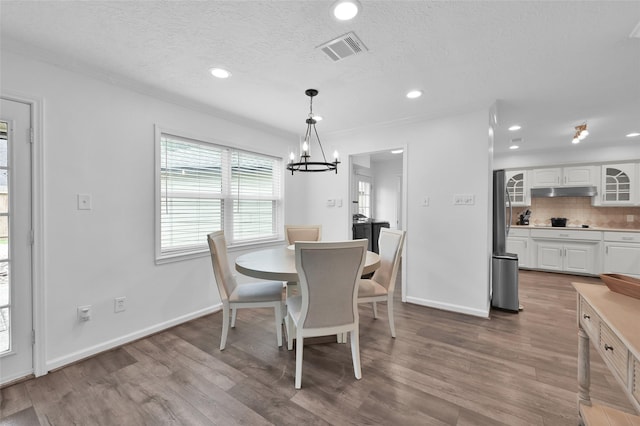 16419 Fox Crossing Ln, Spring, TX 77379 - dining room with a chandelier, wood finished floors, a textured ceiling, recessed lighting, and baseboards