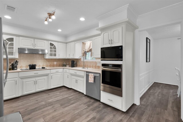 16419 Fox Crossing Ln, Spring, TX 77379 - kitchen featuring black appliances, under cabinet range hood, a sink, glass insert cabinets, and dark wood-style floors