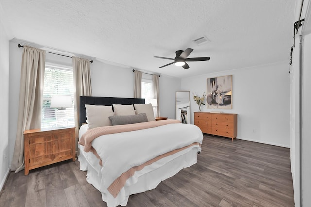 16419 Fox Crossing Ln, Spring, TX 77379 - bedroom featuring multiple windows, a textured ceiling, wood finished floors, a ceiling fan, and baseboards