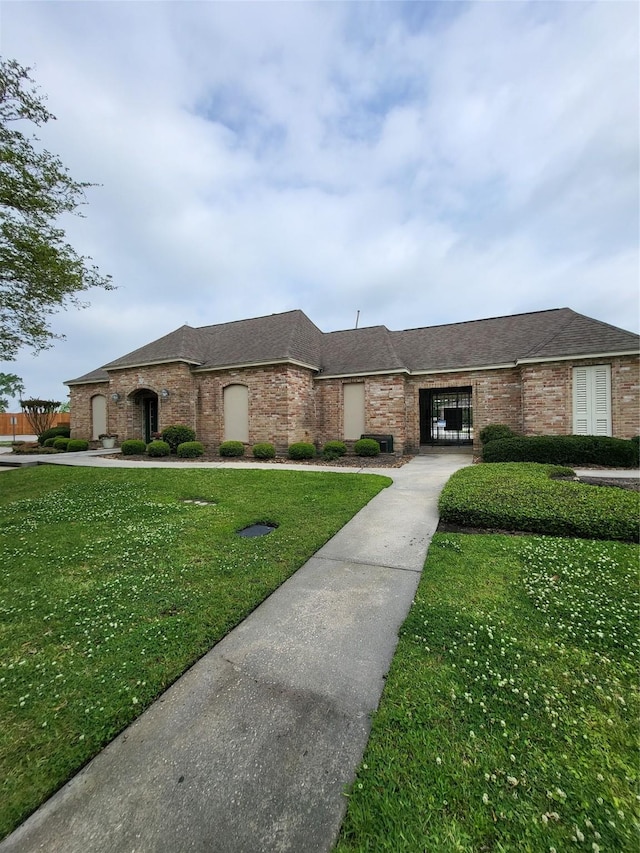 16419 Fox Crossing Ln, Spring, TX 77379 - view of front of property featuring a front yard and brick siding