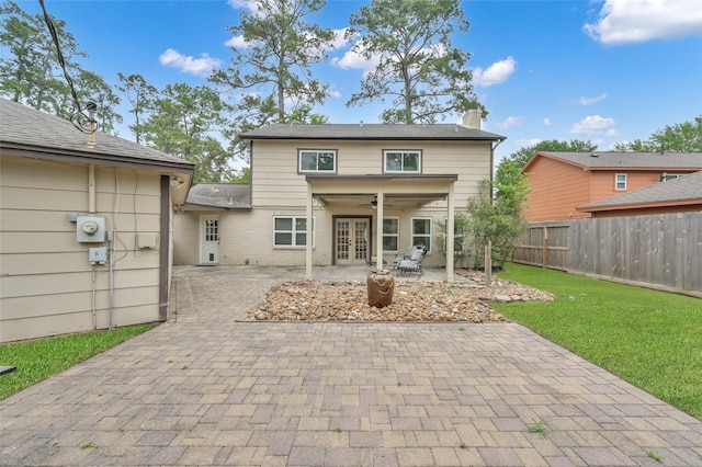 16419 Fox Crossing Ln, Spring, TX 77379 - rear view of house with french doors, a patio, a chimney, brick siding, and a ceiling fan