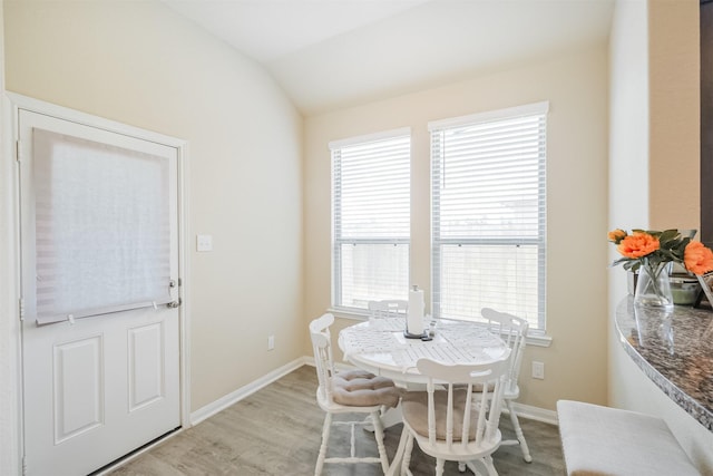 14657 E Pine Heart Dr, Conroe, TX 77302 - dining room featuring lofted ceiling, light wood-style floors, healthy amount of natural light, and baseboards