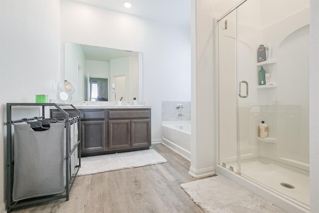 14657 E Pine Heart Dr, Conroe, TX 77302 - bathroom with wood finished floors, a stall shower, a bath, vanity, and baseboards