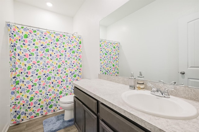 14657 E Pine Heart Dr, Conroe, TX 77302 - bathroom with toilet, vanity, wood finished floors, a shower with shower curtain, and recessed lighting