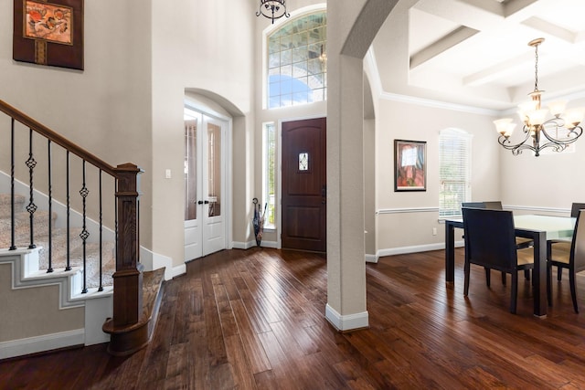 2322 Dolan Springs Ln, Friendswood, TX 77546 - foyer featuring a chandelier, arched walkways, stairway, dark wood finished floors, and beamed ceiling
