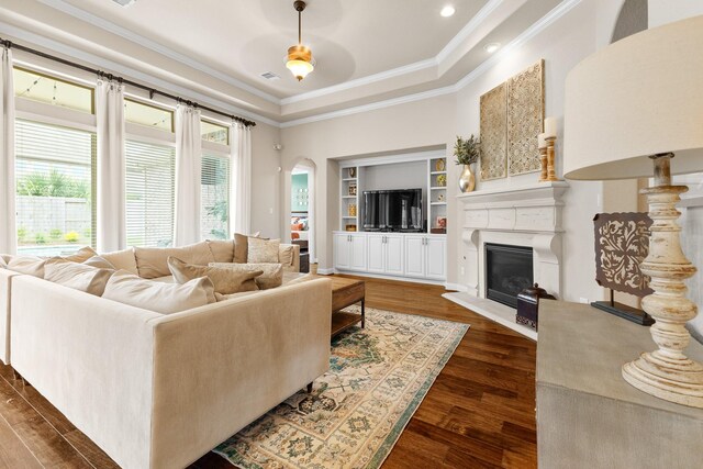 2322 Dolan Springs Ln, Friendswood, TX 77546 - living room featuring a raised ceiling, healthy amount of natural light, dark wood finished floors, and ornamental molding