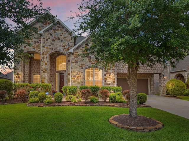2322 Dolan Springs Ln, Friendswood, TX 77546 - view of front facade featuring stone siding, driveway, and a front yard