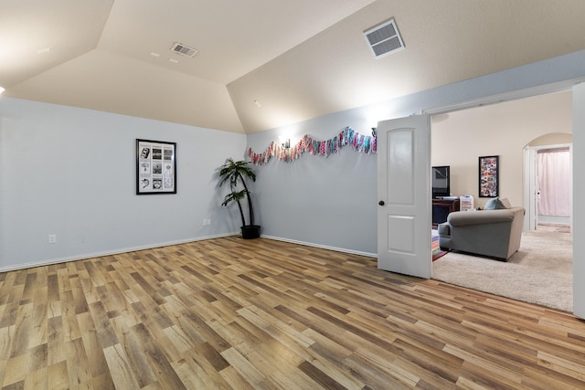 2322 Dolan Springs Ln, Friendswood, TX 77546 - empty room featuring lofted ceiling, arched walkways, wood finished floors, and baseboards