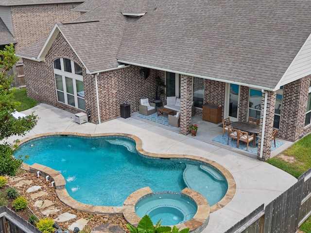 2322 Dolan Springs Ln, Friendswood, TX 77546 - view of swimming pool with a patio area, a pool with connected hot tub, a fenced backyard, and outdoor lounge area