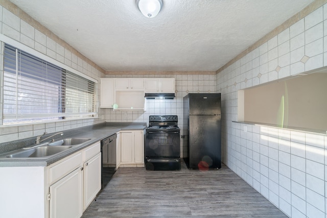 751 Terryhollow St, Channelview, TX 77530 - kitchen featuring black appliances, a sink, under cabinet range hood, a textured ceiling, and white cabinetry