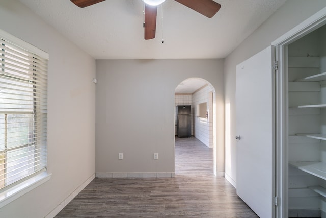 751 Terryhollow St, Channelview, TX 77530 - spare room featuring a ceiling fan, arched walkways, and wood finished floors