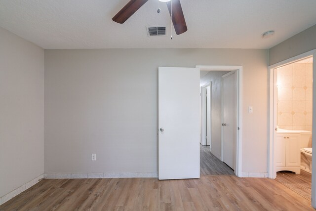 751 Terryhollow St, Channelview, TX 77530 - unfurnished bedroom with light wood finished floors, baseboards, a ceiling fan, and ensuite bathroom