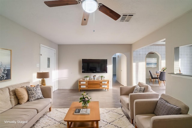 751 Terryhollow St, Channelview, TX 77530 - living area featuring arched walkways, a ceiling fan, and wood finished floors