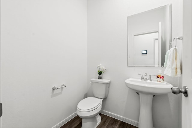 519 Newcomb Hollow Dr, Conroe, TX 77304 - bathroom with wood finished floors, toilet, and baseboards
