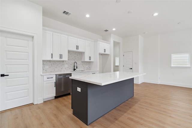 4629 Balkin St, Houston, TX 77021 - kitchen featuring stainless steel dishwasher, a sink, a center island, white cabinetry, and recessed lighting