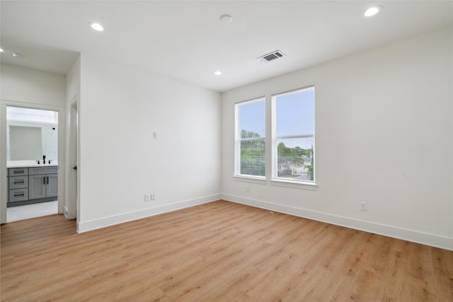 4629 Balkin St, Houston, TX 77021 - spare room featuring light wood-type flooring, baseboards, recessed lighting, and a sink