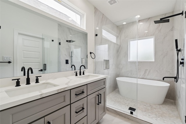 4629 Balkin St, Houston, TX 77021 - full bathroom featuring a marble finish shower, double vanity, plenty of natural light, and a freestanding tub