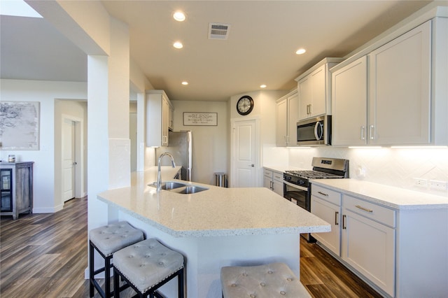 3033 Myrtle Sunset Dr, Katy, TX 77493 - kitchen with appliances with stainless steel finishes, a sink, tasteful backsplash, white cabinets, and recessed lighting