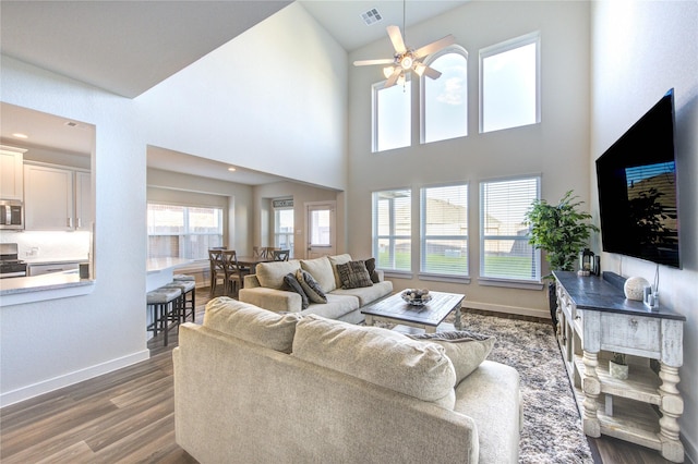 3033 Myrtle Sunset Dr, Katy, TX 77493 - living area featuring wood finished floors, a ceiling fan, baseboards, and high vaulted ceiling