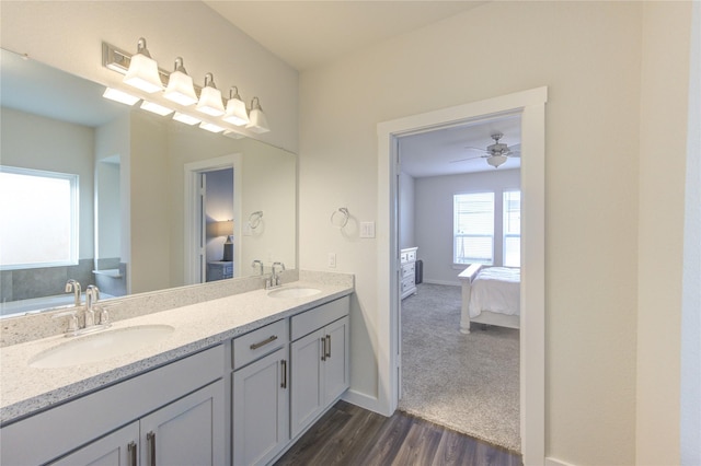 3033 Myrtle Sunset Dr, Katy, TX 77493 - ensuite bathroom featuring double vanity, wood finished floors, and baseboards