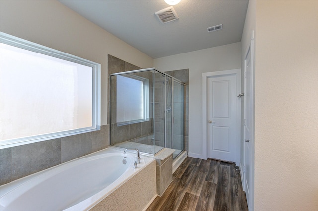3033 Myrtle Sunset Dr, Katy, TX 77493 - bathroom with a garden tub, a stall shower, and wood finished floors