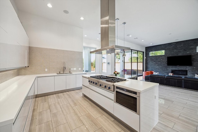 5430 Judalon Ln, Houston, TX 77056 - kitchen featuring stainless steel appliances, modern cabinets, a sink, white cabinets, and island range hood