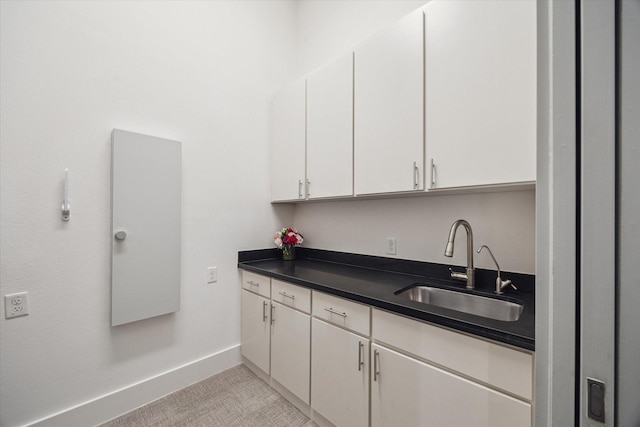5430 Judalon Ln, Houston, TX 77056 - kitchen with a sink, white cabinets, dark countertops, and baseboards