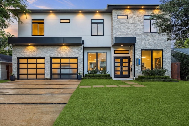5430 Judalon Ln, Houston, TX 77056 - contemporary house with stone siding, concrete driveway, an attached garage, and a lawn
