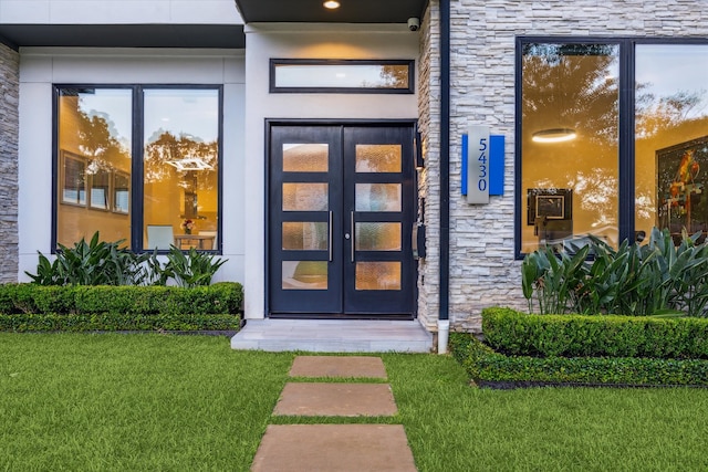 5430 Judalon Ln, Houston, TX 77056 - doorway to property with stone siding, a yard, a surveillance system, and french doors
