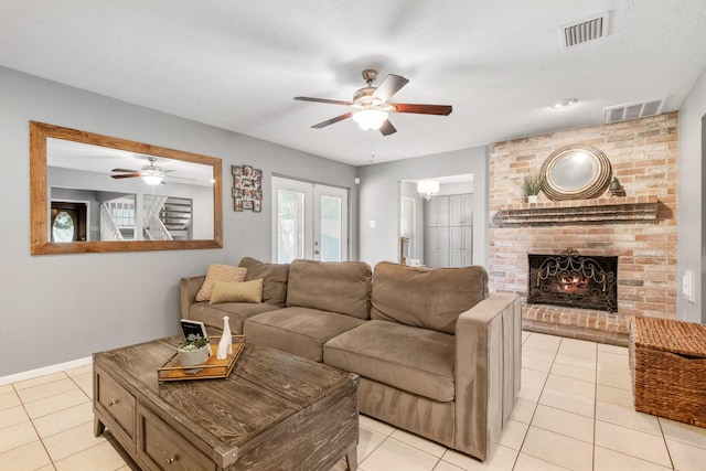 3623 Wells Mark Dr, Humble, TX 77396 - living area featuring ceiling fan, light tile patterned floors, a brick fireplace, and baseboards