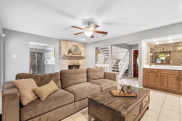 3623 Wells Mark Dr, Humble, TX 77396 - living area with light tile patterned floors, ceiling fan, a fireplace, stairs, and healthy amount of natural light