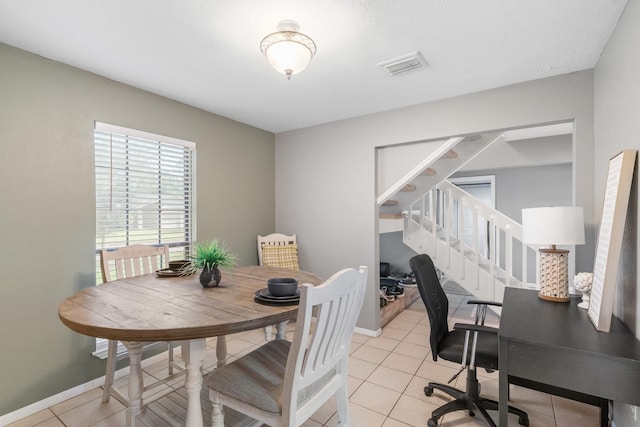3623 Wells Mark Dr, Humble, TX 77396 - dining room featuring stairway, light tile patterned floors, and baseboards