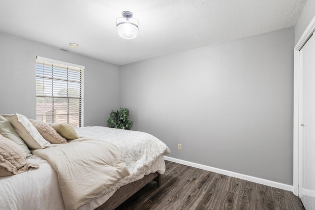 3623 Wells Mark Dr, Humble, TX 77396 - bedroom featuring dark wood finished floors and baseboards