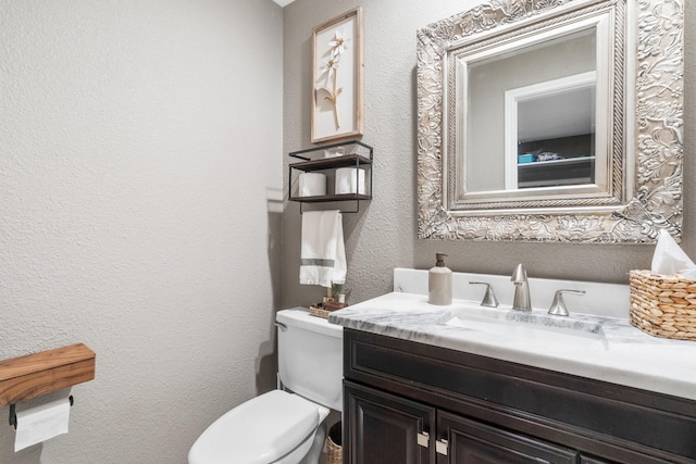 3623 Wells Mark Dr, Humble, TX 77396 - half bathroom featuring vanity, toilet, and a textured wall