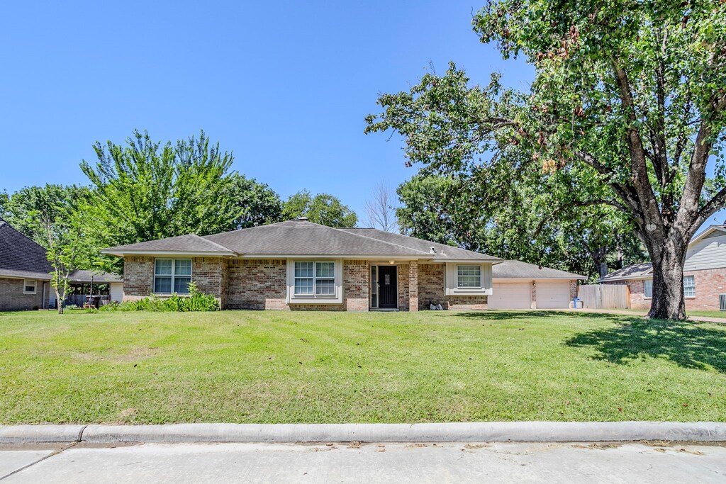 8015 Durklyn Ln, Houston, TX 77070 - view of front of property with brick siding and a detached garage
