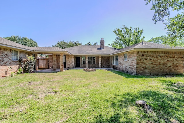 8015 Durklyn Ln, Houston, TX 77070 - back of house featuring a chimney, brick siding, a patio, and an outdoor fire pit