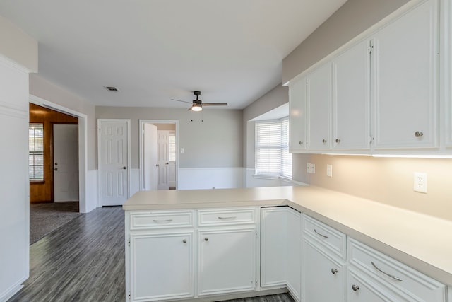 8015 Durklyn Ln, Houston, TX 77070 - kitchen with ceiling fan, a peninsula, white cabinetry, light countertops, and dark wood-style flooring
