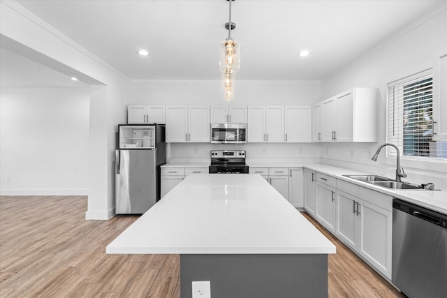 4358 Larkspur St, Houston, TX 77051 - kitchen with appliances with stainless steel finishes, a sink, light countertops, a center island, and light wood-type flooring
